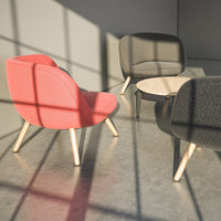Two-toned armchairs in pink and charcoal gray with wooden legs, set against a shadowed, minimalist backdrop.