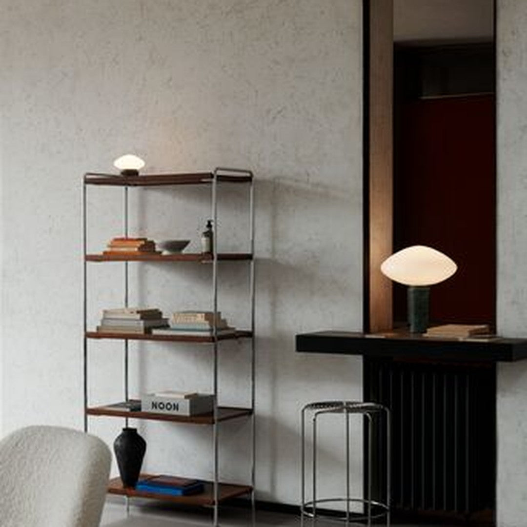 Modern shelving unit in wood and steel, featuring a neutral palette with warm tones and sleek lines. Elegant decor accents.