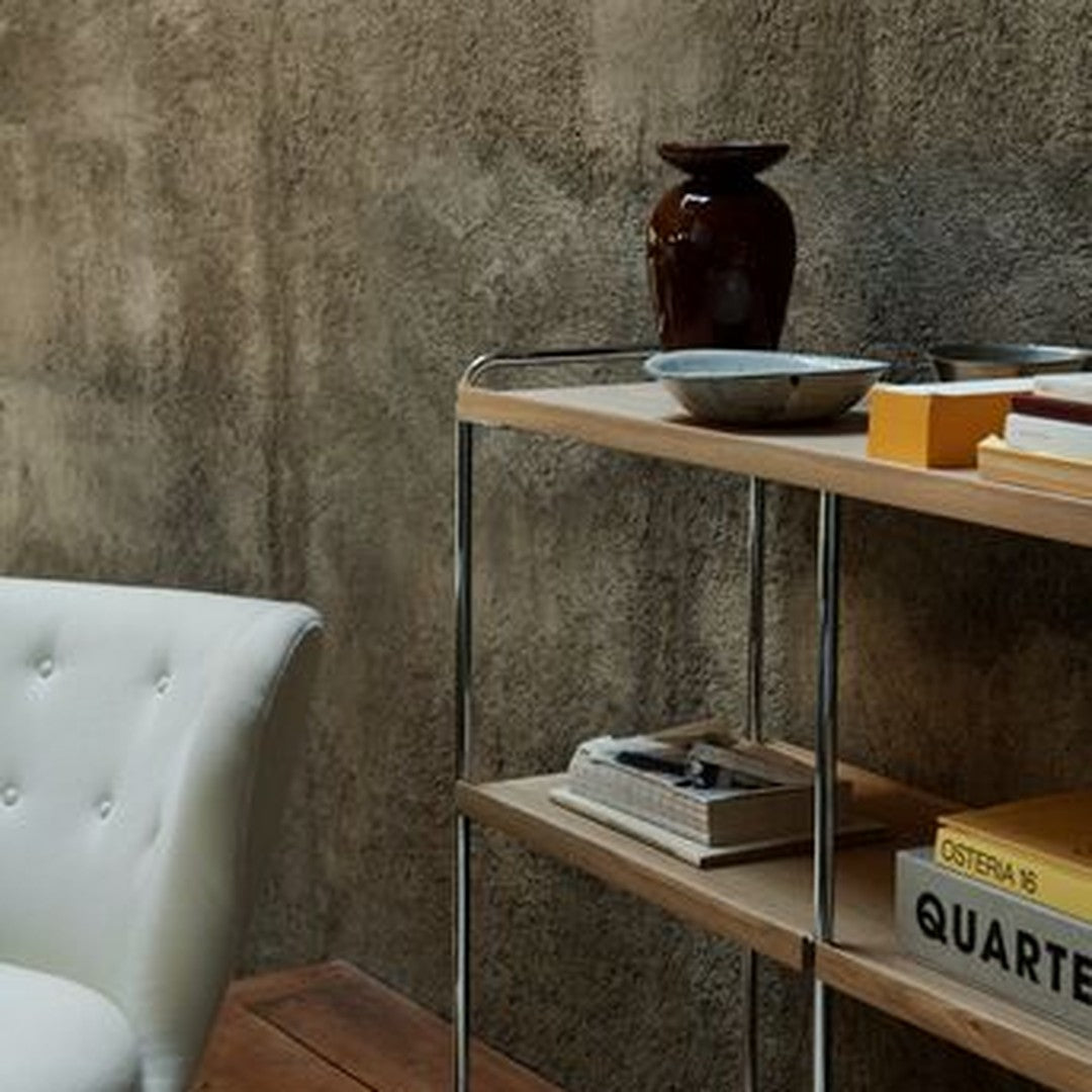 "Modern wooden shelf with chrome accents, featuring earthy tones and minimalist decor against a textured gray wall."