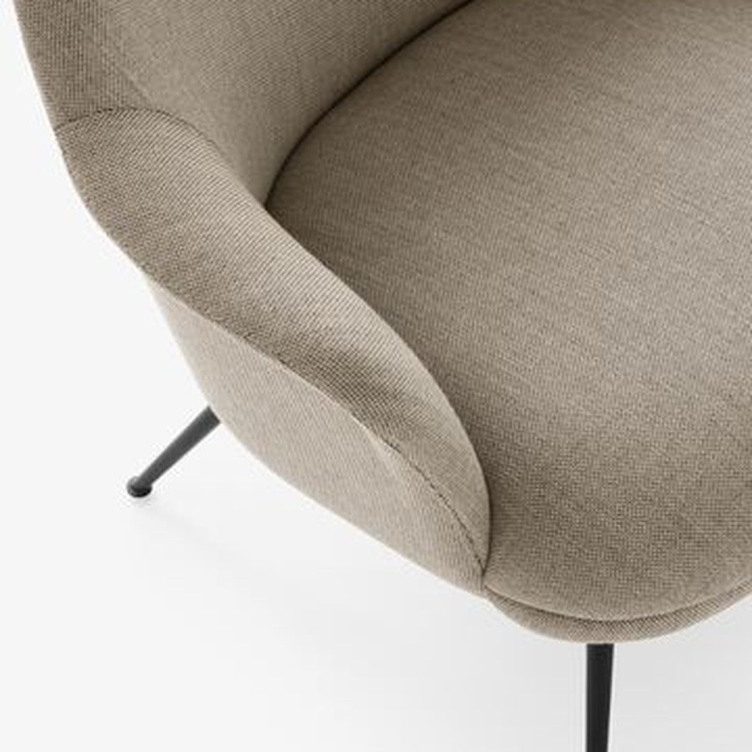 Beige textured upholstery with soft curves and black metal legs. Modern, minimalist chair design.