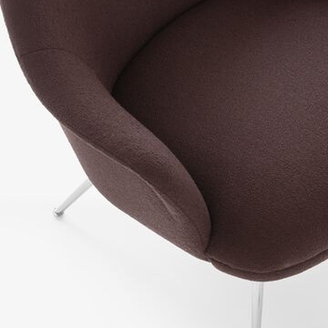 Dark brown upholstered chair with a smooth, curved design and sleek silver legs. Ideal modern accent piece.