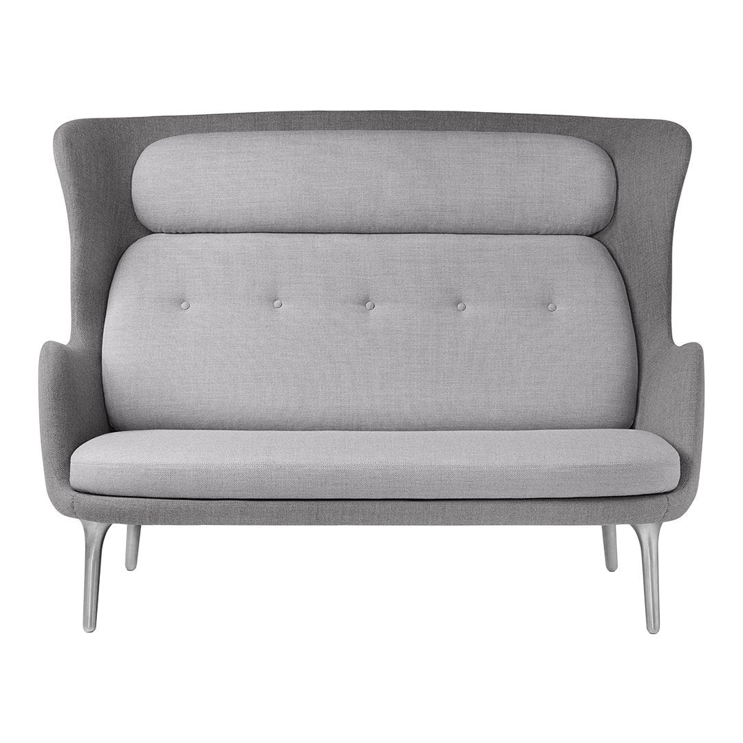 Gray upholstered loveseat with a smooth texture and subtle tufted pattern. Soft contemporary design for modern spaces.