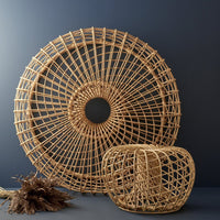 Natural rattan decor featuring circular and geometric patterns, showcasing beige tones against a dark backdrop.