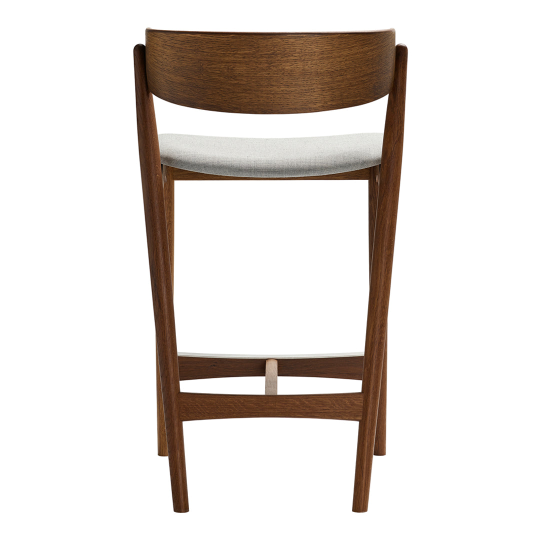Sturdy wooden bar stool with a rich brown finish and a light, textured fabric seat. Elegant and modern design.