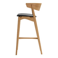 Oak bar stool with a natural finish and a sleek black cushioned seat. Minimalist design with clean lines.