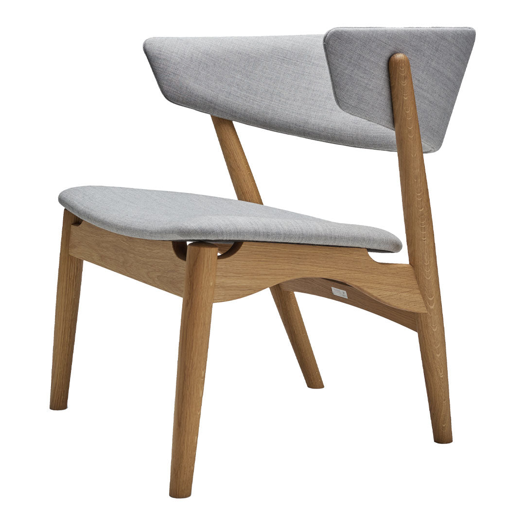 Gray upholstered chair with a smooth wooden frame, featuring a minimalist design and simple, modern patterns.