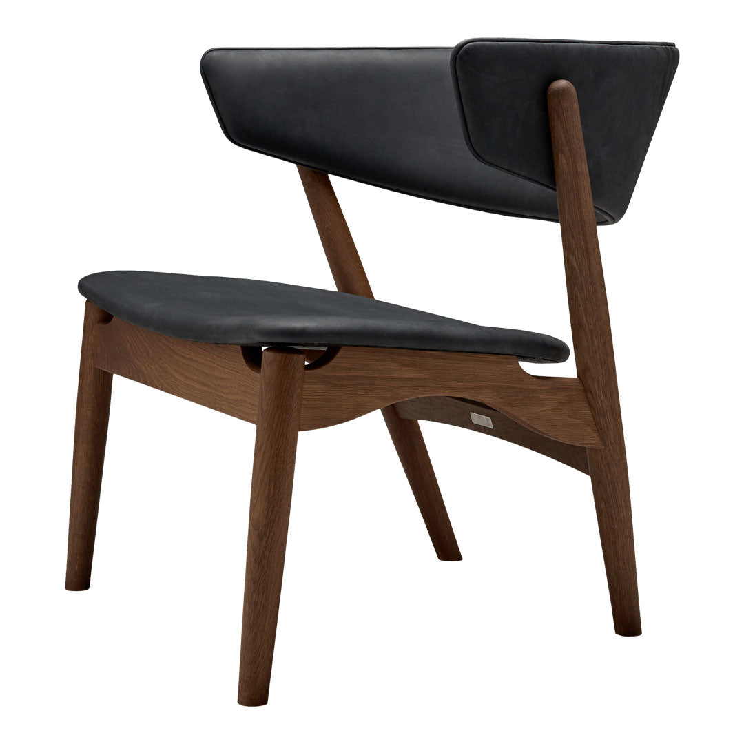 Modern chair featuring a sleek black leather seat and backrest with warm walnut wood legs and a minimalist design.