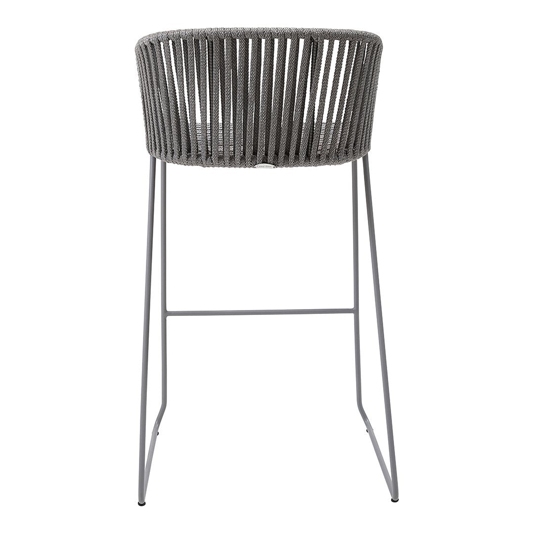 Grey woven bar stool with a minimalistic design and sleek metal legs. Ideal for modern interiors.