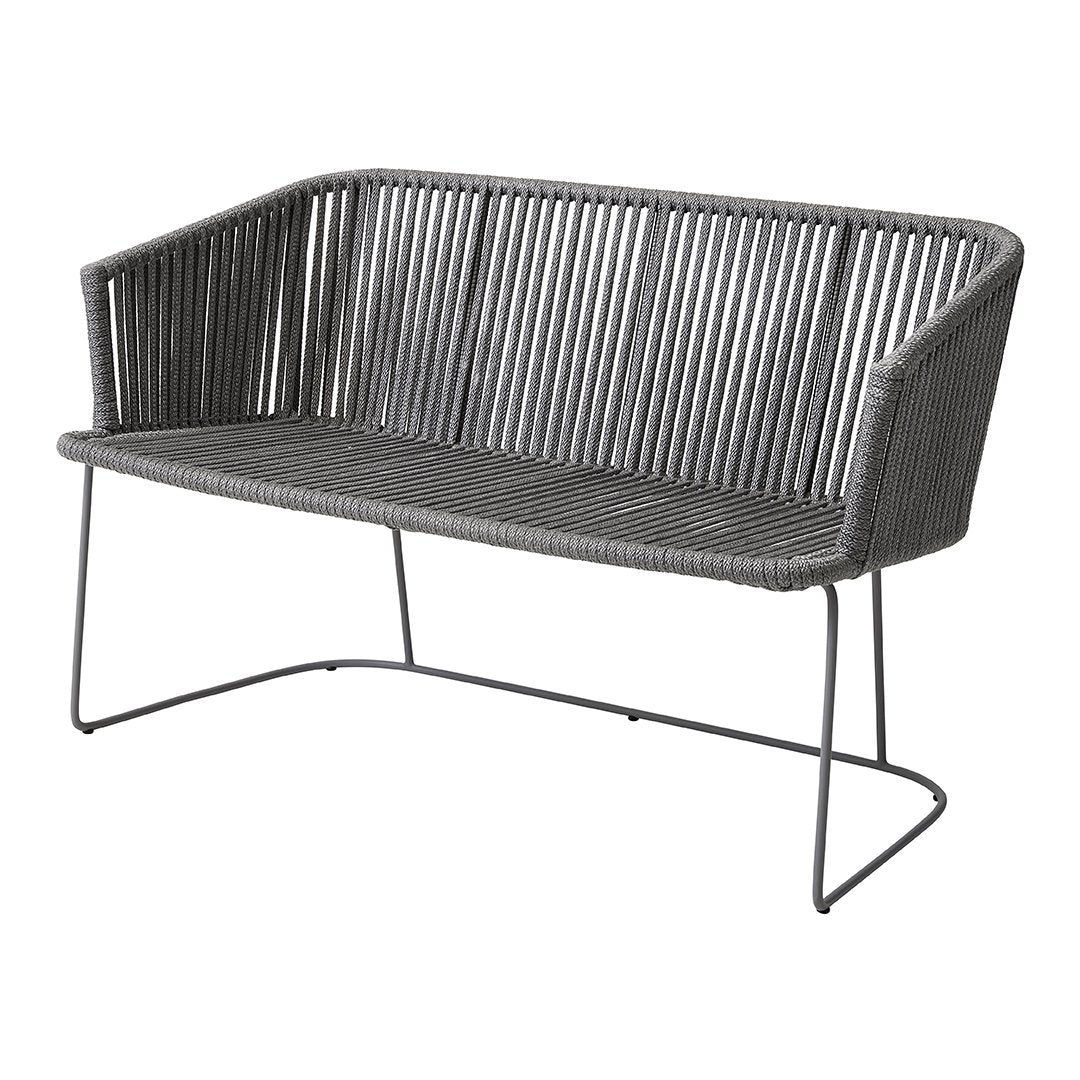 Gray woven loveseat with vertical striped pattern and minimalist metal frame. Ideal for modern outdoor spaces.
