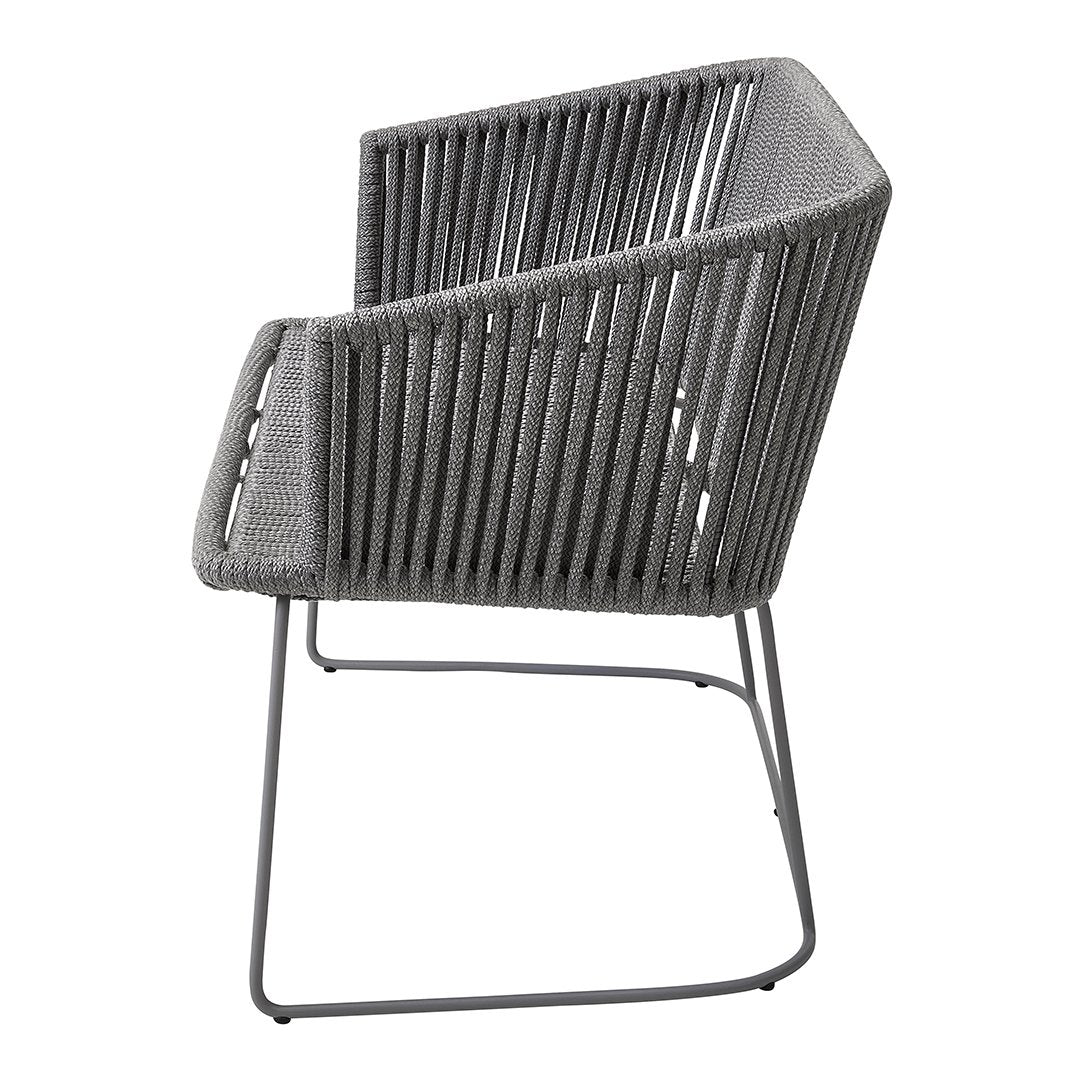 Gray woven armchair with a modern striped pattern and minimalistic metal legs. Perfect for contemporary decor.