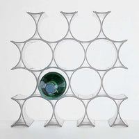 Modern clear acrylic wine rack featuring a geometric design with circular patterns and one green bottle accent.