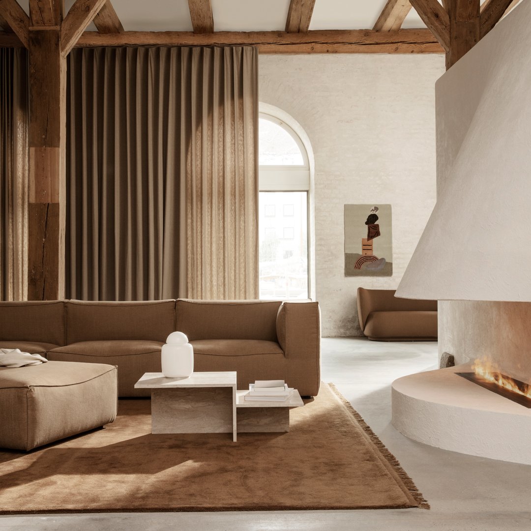 Warm brown tones with textured curtains and a soft rug, creating a cozy, contemporary living space.