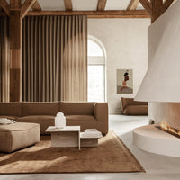Warm brown tones with textured curtains and a soft rug, creating a cozy, contemporary living space.