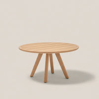 Natural wood round coffee table with slatted surface and light beige legs against a subtle beige background.