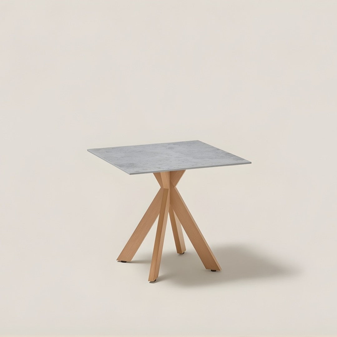 Square table with a gray marble top and natural wood tripod legs, featuring a modern minimalist design.