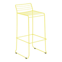 Bright yellow wire bar stool with sleek, modern lines and minimalist design for contemporary spaces.