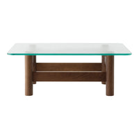 Glass top coffee table with brown wooden legs; sleek, modern design with minimalistic style.