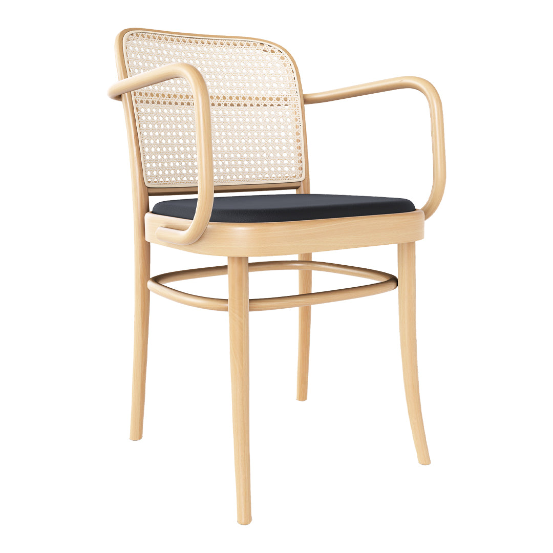Natural rattan chair with a light wood frame and deep navy blue cushion, featuring a woven backrest pattern.