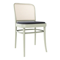 Light green chair with natural woven rattan back and a dark blue cushioned seat, featuring clean, modern lines.