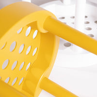 Vibrant yellow chair with circular cutouts, contrasted by sleek white legs and a minimalist design.