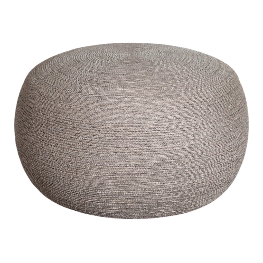 Round pouf in soft gray tones with textured, layered pattern for stylish, modern decor.