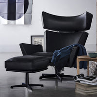 Modern black leather lounge chair with matching ottoman, featuring sleek lines and minimalist design. Sophisticated decor.