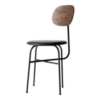 Black metal chair with a sleek round seat and a wood-patterned backrest. Modern minimalist design.