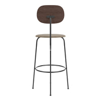 Stylish bar stool in dark wood and black metal, featuring a textured beige seat for a modern, minimalist look.