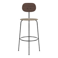 Stylish bar stool in dark wood, beige seat fabric, and black metal legs, featuring a minimalist design.