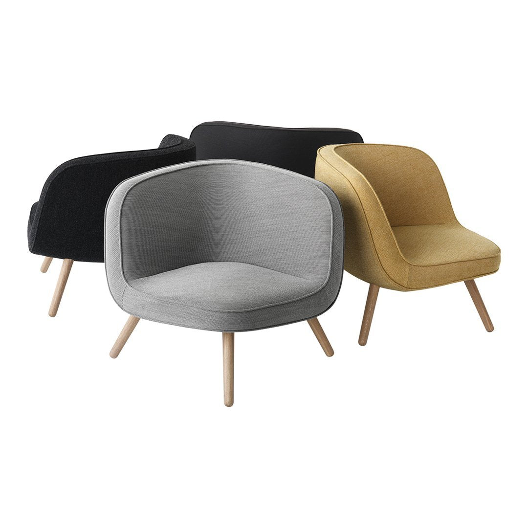 Modern accent chairs in black, gray, and mustard with smooth textured upholstery and wooden legs.
