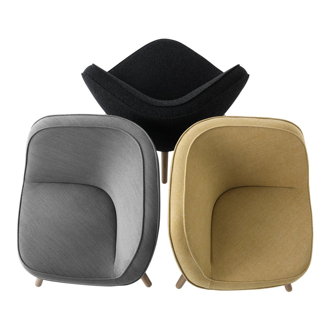 Set of three modern armchairs in black, gray, and mustard yellow, showcasing smooth textures and contemporary design.