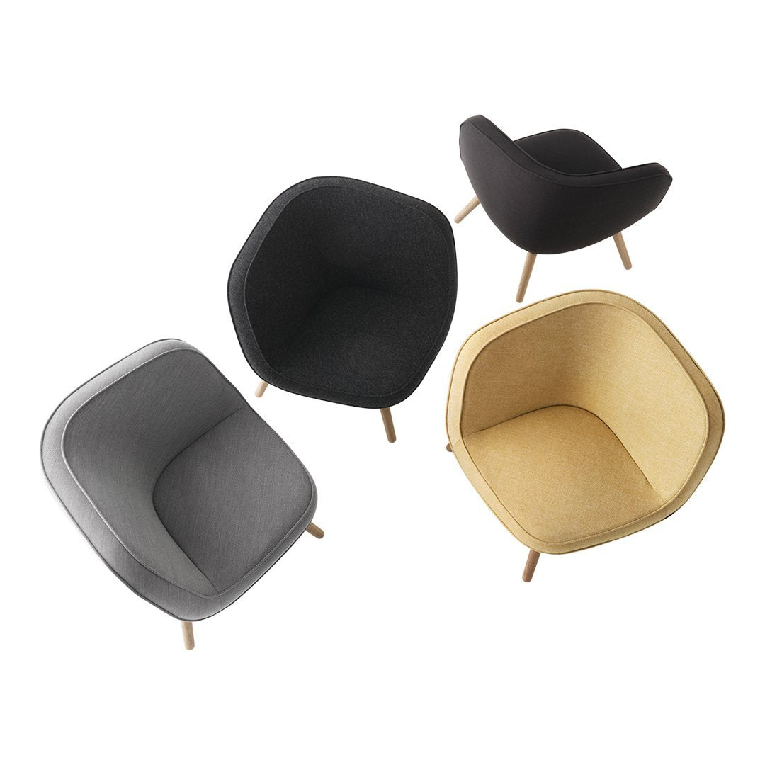 Cozy armchairs in gray, black, and mustard yellow with smooth, modern patterns and wooden legs.