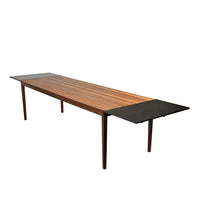 Wooden dining table with rich brown stripes and sleek black side panels, combining modern elegance with natural texture.