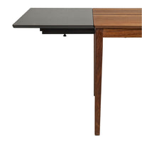 Wooden dining table with a contrasting black extension, featuring a smooth finish and sleek lines in warm brown tones.