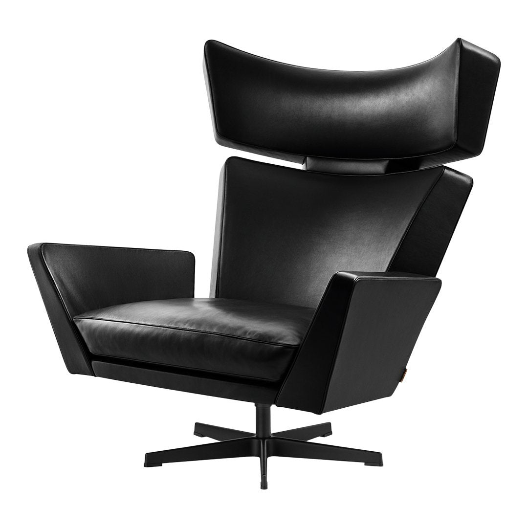 Sleek black leather armchair with a modern design, featuring smooth surfaces and bold angular lines.