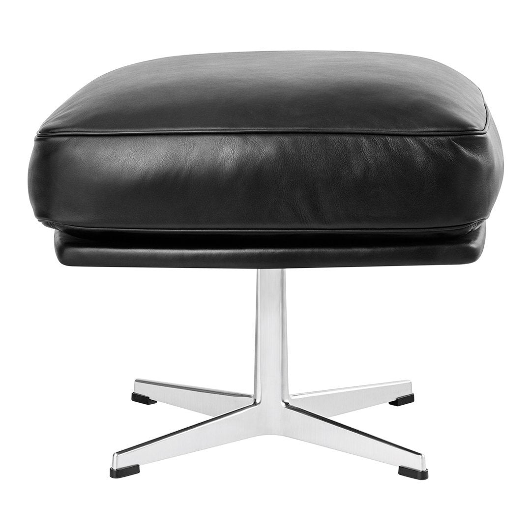 Black leather ottoman with sleek chrome base, featuring a minimalistic design and smooth finish. Perfect for modern decor.