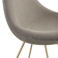Gray textured chair upholstery with subtle pattern and stylish gold metal legs.