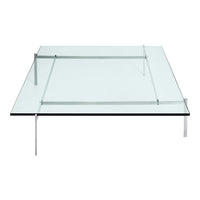 Clear glass coffee table with sleek stainless steel legs and minimalist design, showcasing modern elegance and simplicity.