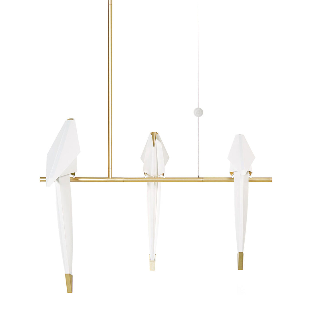 Elegant gold pendant light with three white fabric shades, featuring a minimalist design and modern aesthetic.