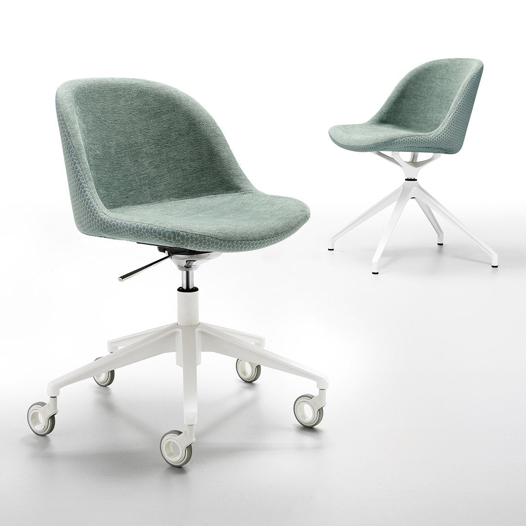 Light green upholstered chair with a smooth texture and white wheels on a minimalist design base.