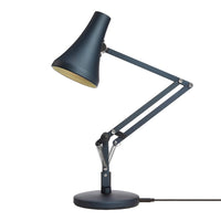 Blue desk lamp with a sleek design and matte finish, featuring a gold interior and adjustable arm.