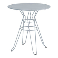 Round silver metal table with a modern wire base, featuring a sleek, minimalist design and smooth surface.