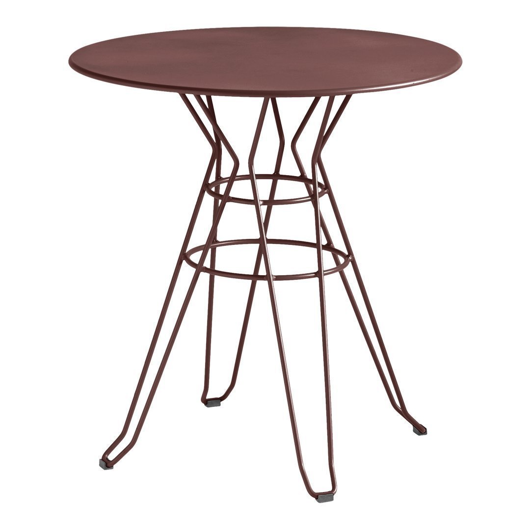 Round table with a deep burgundy top and geometric wire base in matching burgundy, ideal for modern decor.