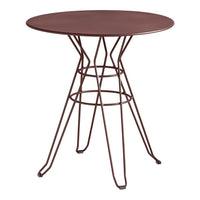Round table with a deep burgundy top and geometric wire base in matching burgundy, ideal for modern decor.
