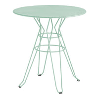 Mint green round table with a geometric wire base, adding a modern touch to any space.