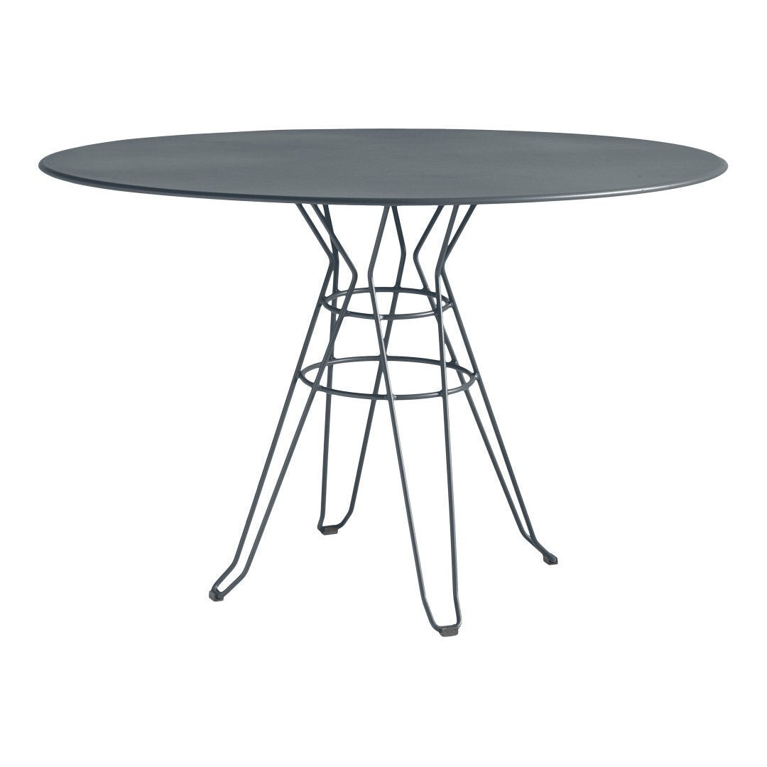 Sleek oval table with a dark gray top and black wire legs, featuring a minimalist design and modern patterns.
