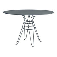 Sleek oval table with a dark gray top and black wire legs, featuring a minimalist design and modern patterns.