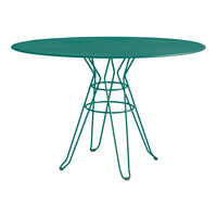 Teal round metal table with a geometric wire base, perfect for modern outdoor or indoor settings.