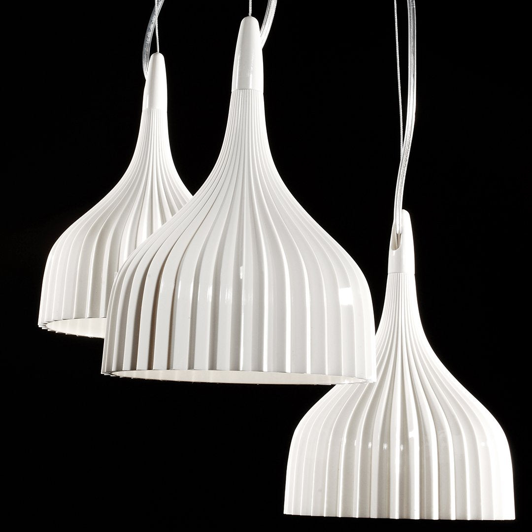 White pendant lamps with ribbed texture and a sleek design, adding elegance to any space.