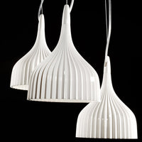 White pendant lamps with ribbed texture and a sleek design, adding elegance to any space.